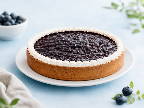 Pay de queso con moras sin azúcar de Pastelerías Marisa, postre artesanal con relleno de queso y cobertura de moras, elaborado sin azúcar añadida.